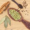 a wooden spoon filled with seeds on top of a wooden table